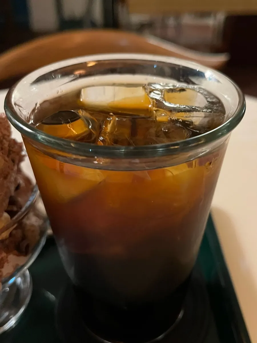 A glass of decaf cold brew filled with ice