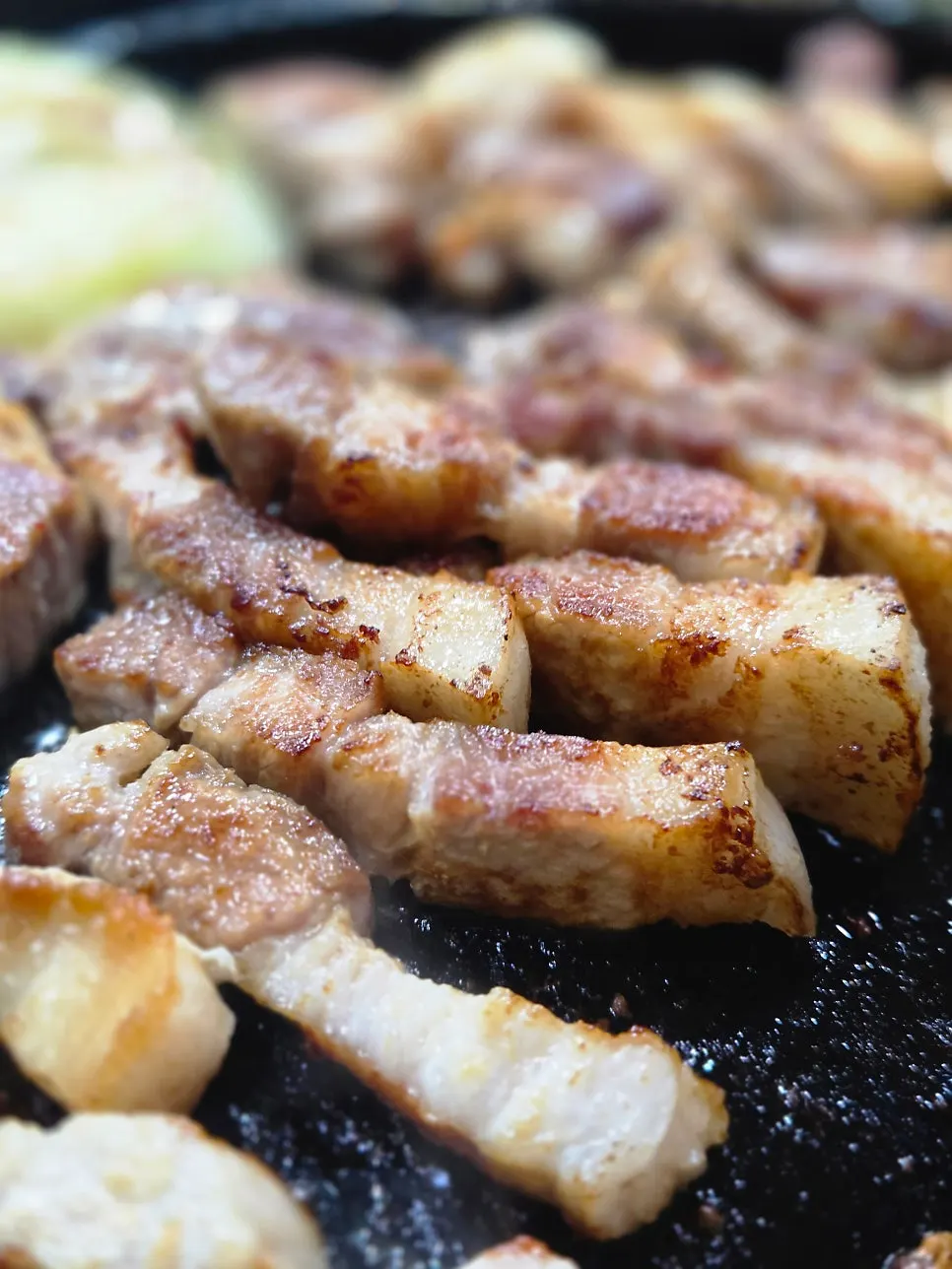 A fully grilled piece of pork belly