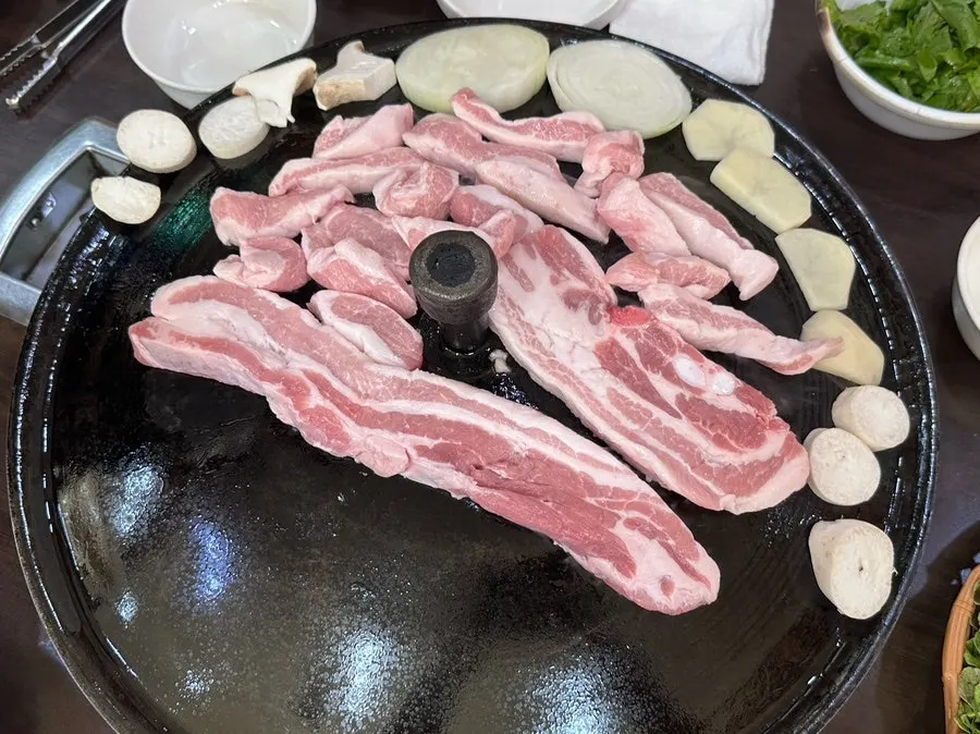 Staff grilling thick-cut pork