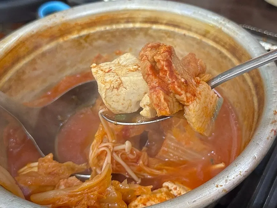 Stew and a bowl of rice set on the table