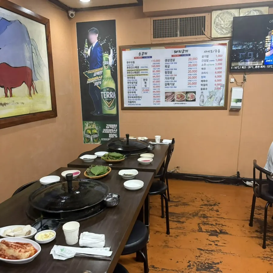 Restaurant interior with cauldron-lid grill tables