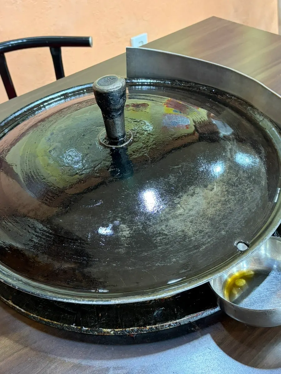 Freshly oiled cauldron-lid grill