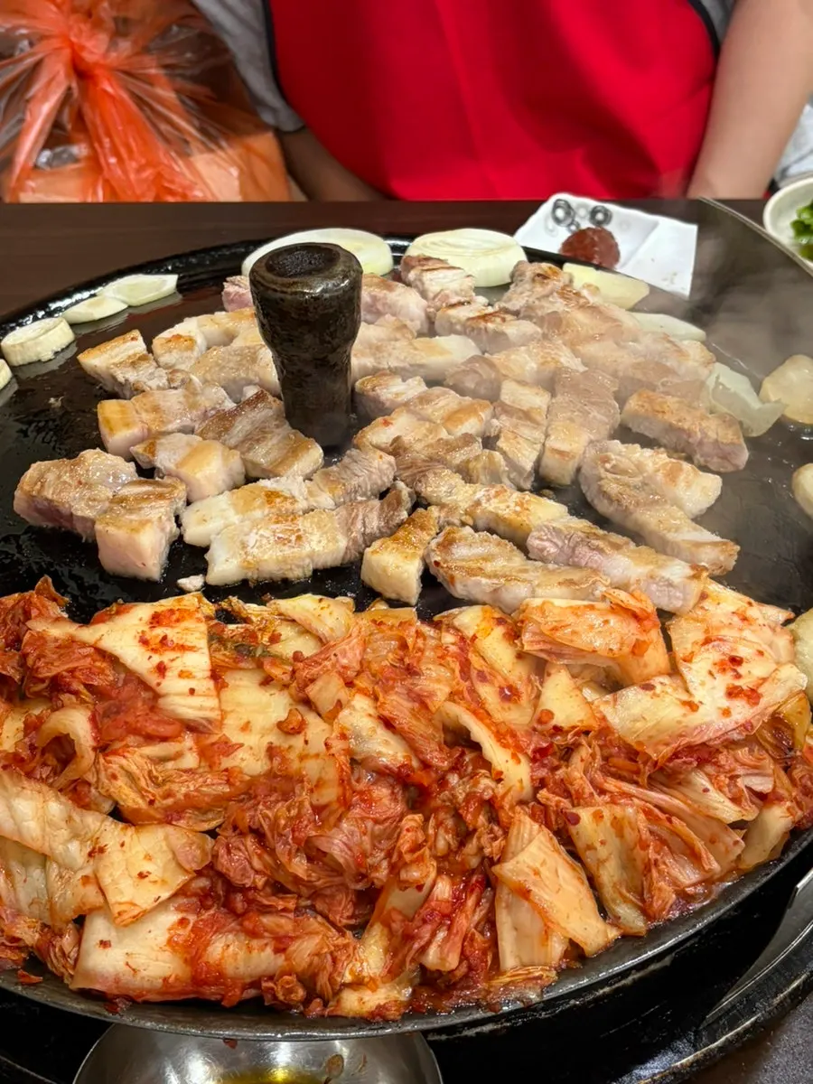Pork belly, mushrooms, onion, and kimchi on the grill