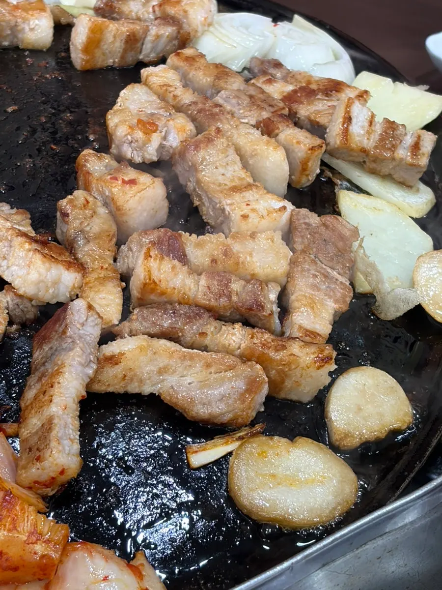 Pork belly cut into bite-sized pieces and grilled by staff