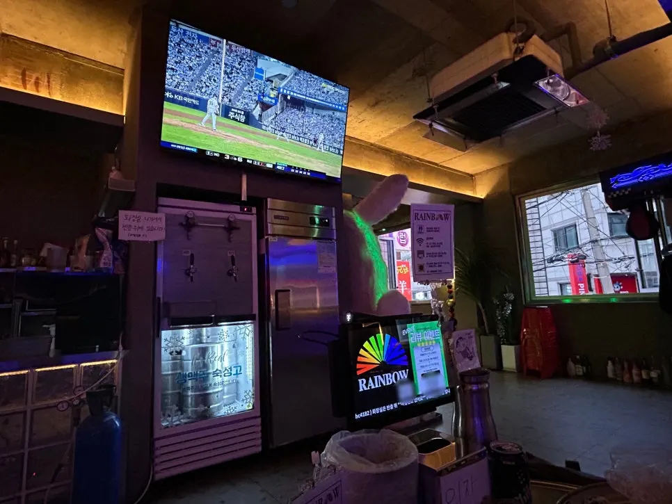 Rainbow Pocha dining hall with a baseball broadcast screen