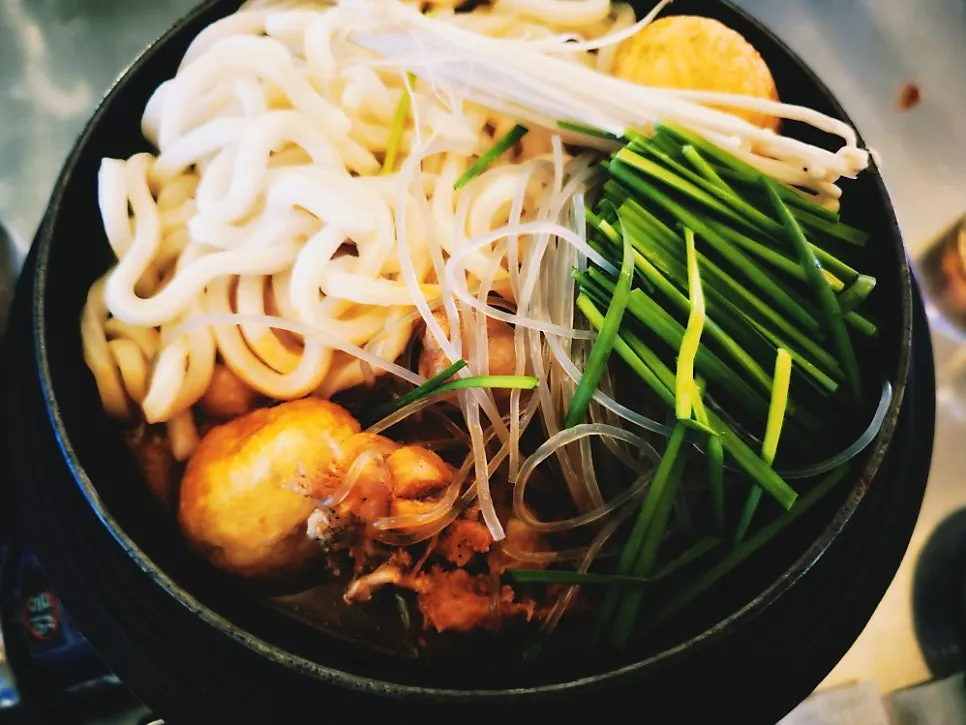 Dakbokkeumtang served in a jar-shaped earthenware pot