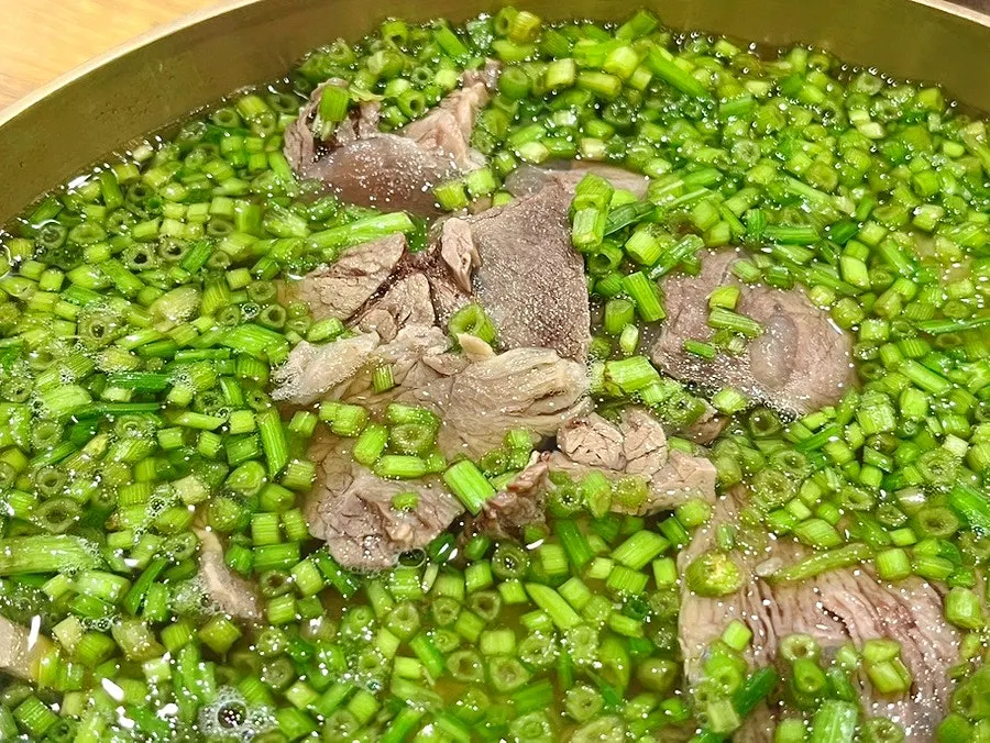 Close-up of the rich broth at a Wangsimni gomtang restaurant