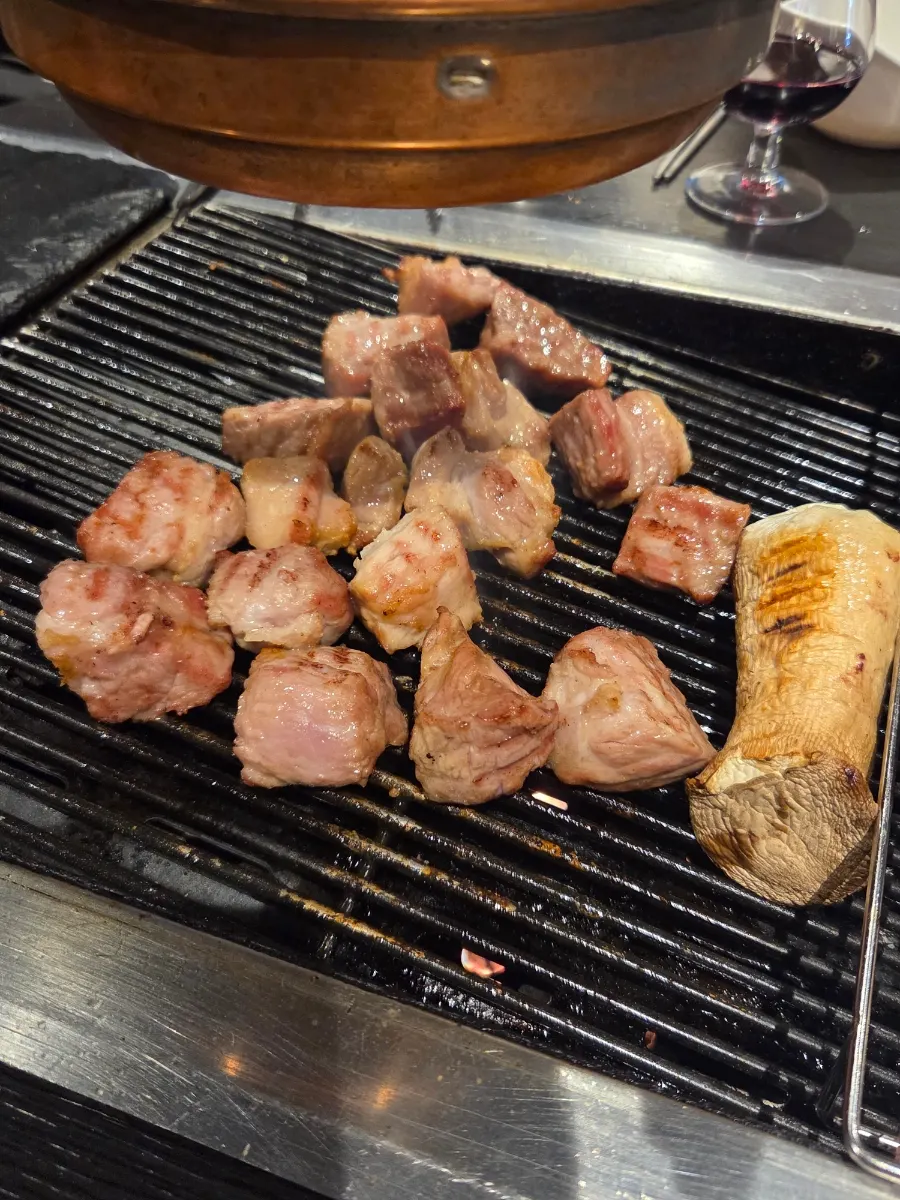 Pork neck cooking on the grill