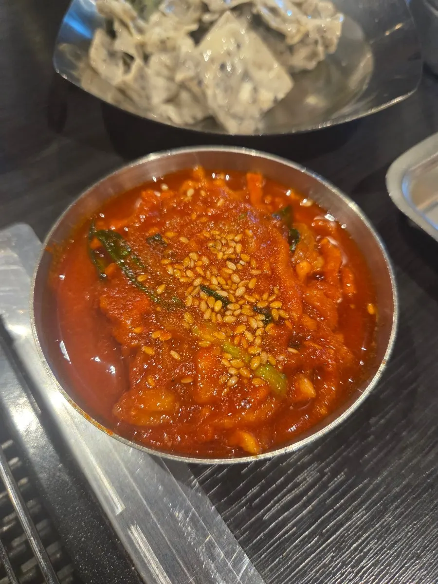 Plate of meat topped with sauce