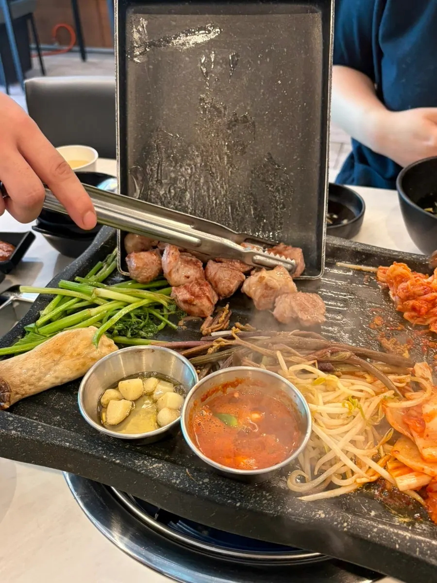 Cooked meat served alongside grilled vegetables