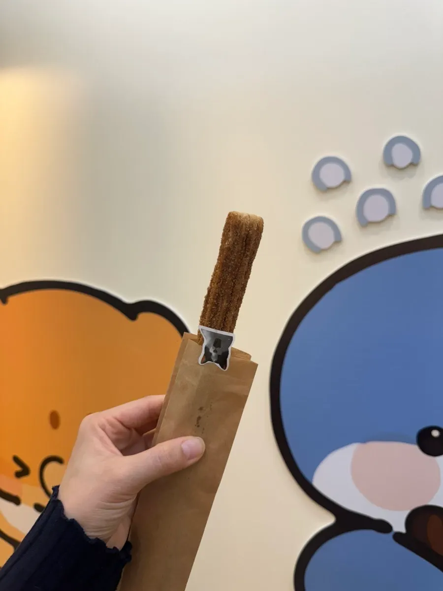 A single churro coated evenly in sugar