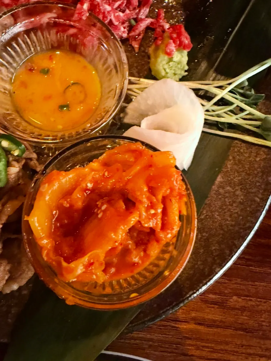 A wrap of beef tartare and seared beef in pickled radish