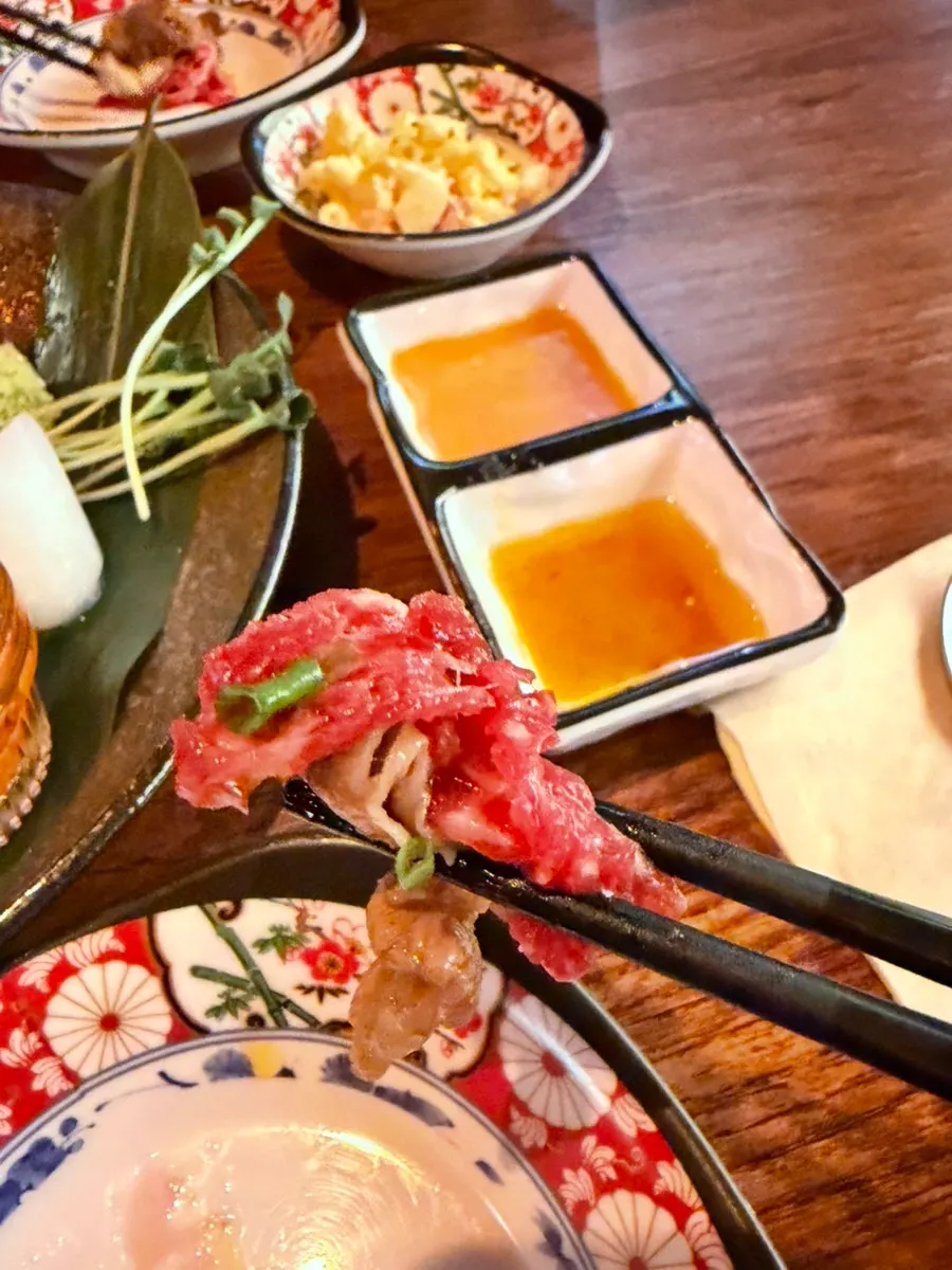 Plate with peanut sauce and sesame oil on the side