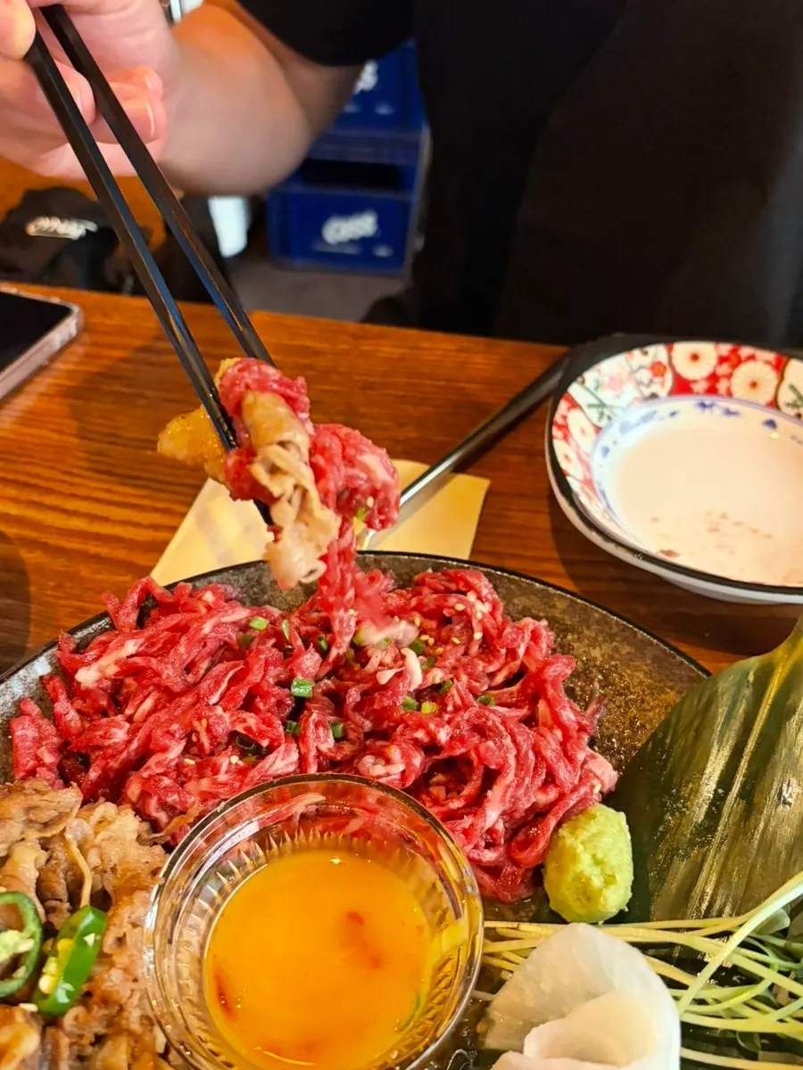 Table with beef tartare wrap and fried chicken together
