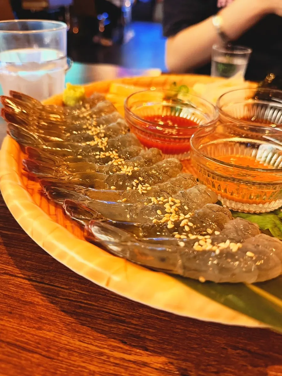 A glossy plate of same-day raw shrimp sashimi