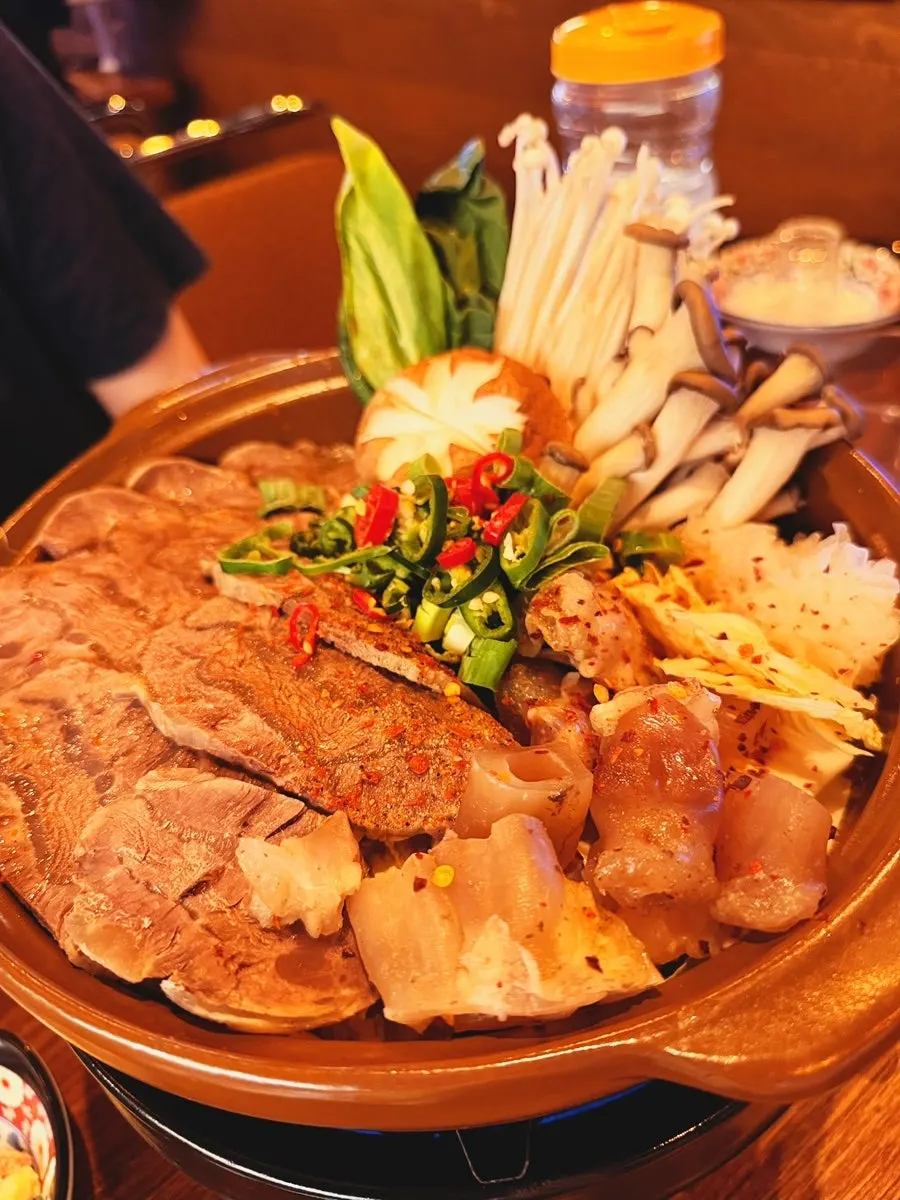 Softly boiled beef shank visible in the hotpot broth