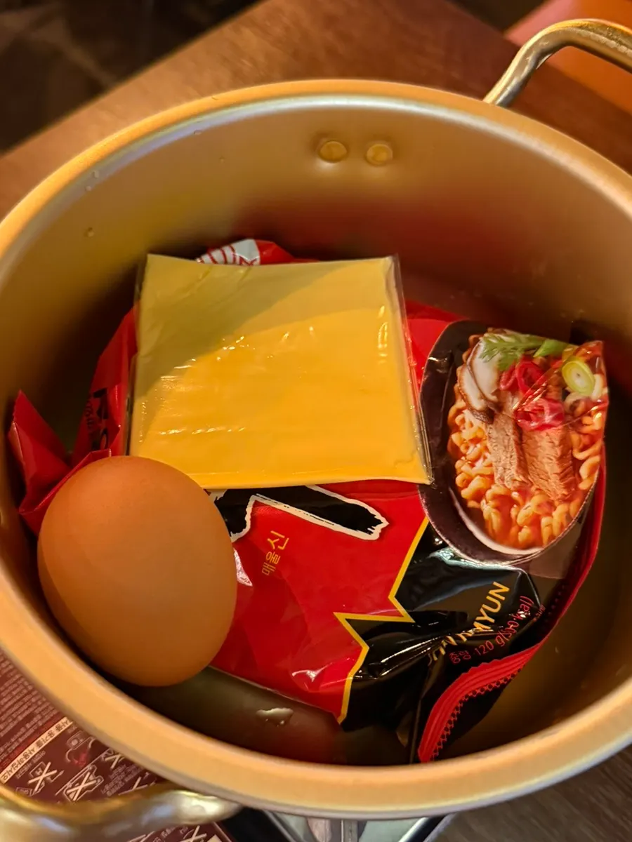 Self-serve ramen set with ramen, water, cheese, and egg