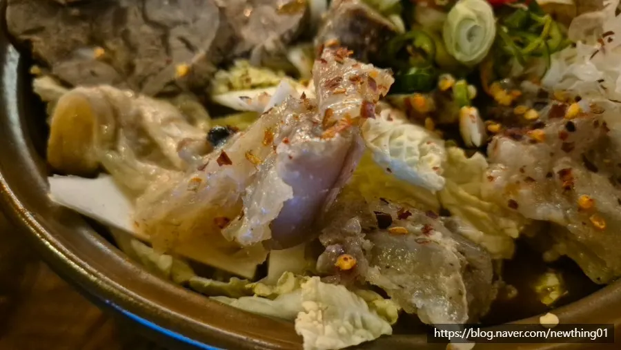 A bowl of hot pot with chewy beef tendon and vegetables