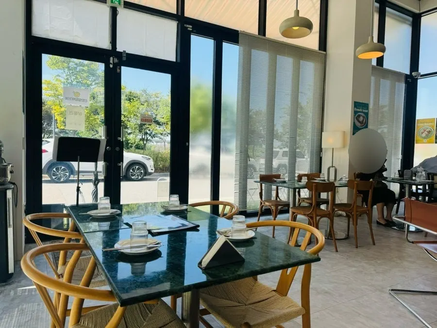 Interior of When You Bite with white tones and plants