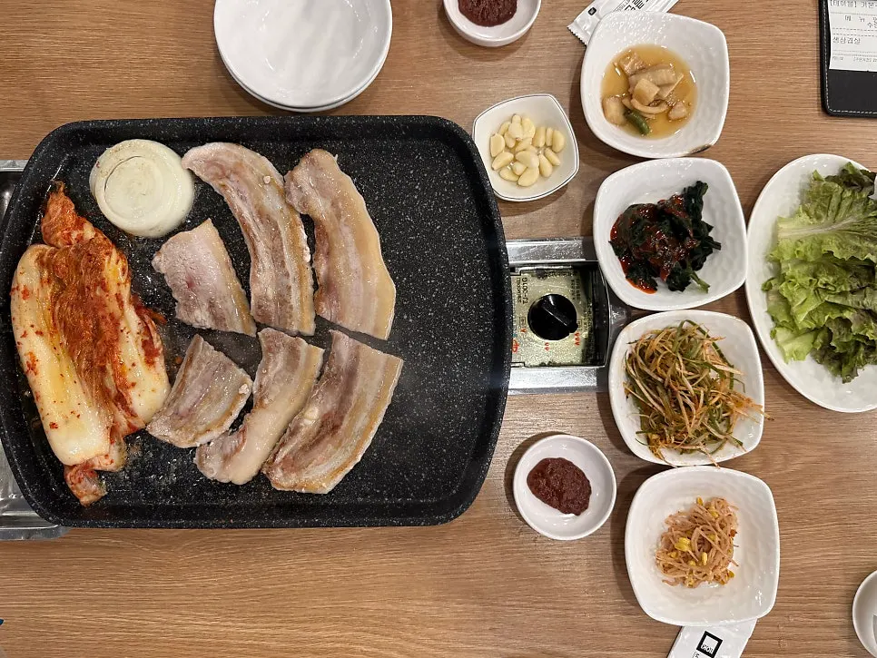 Table spread with scallion salad, bean sprouts, and other basic side dishes