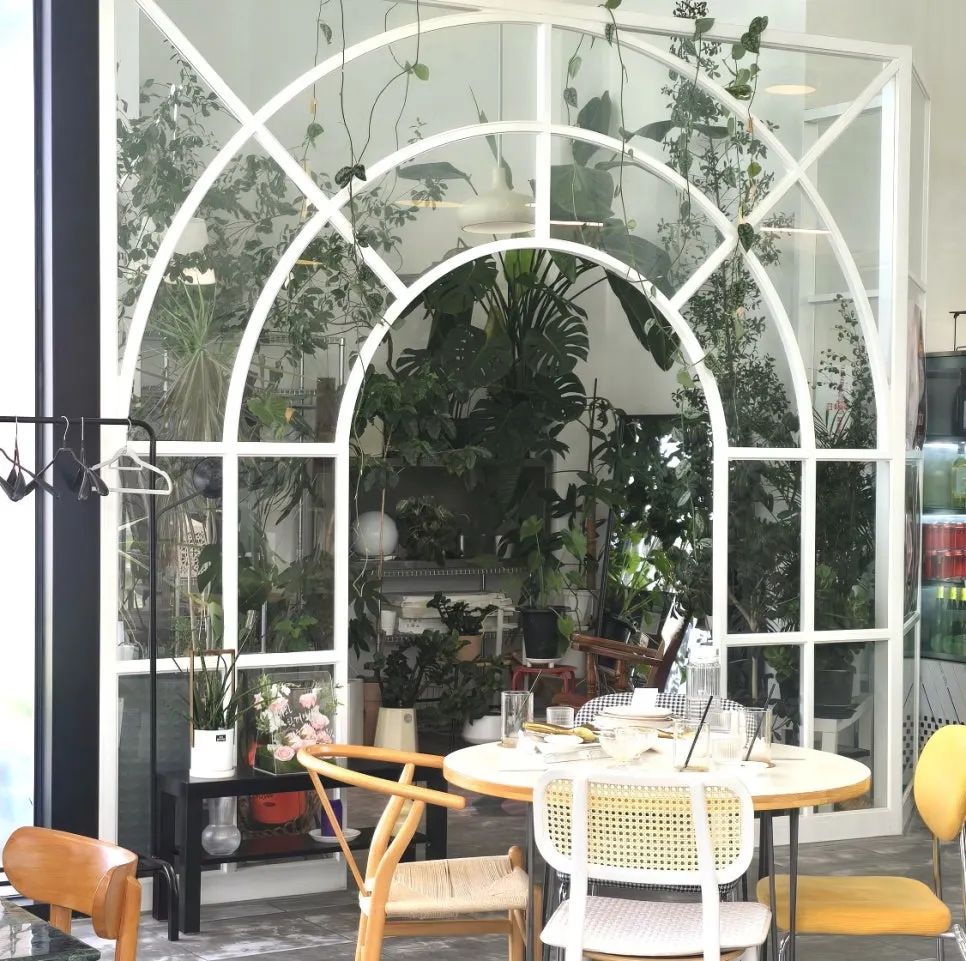 Interior decorated with greenery and an arched partition wall