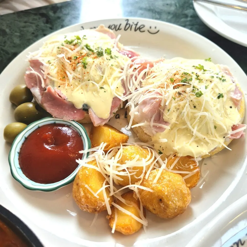 Egg Benedict topped with poached egg and hollandaise sauce