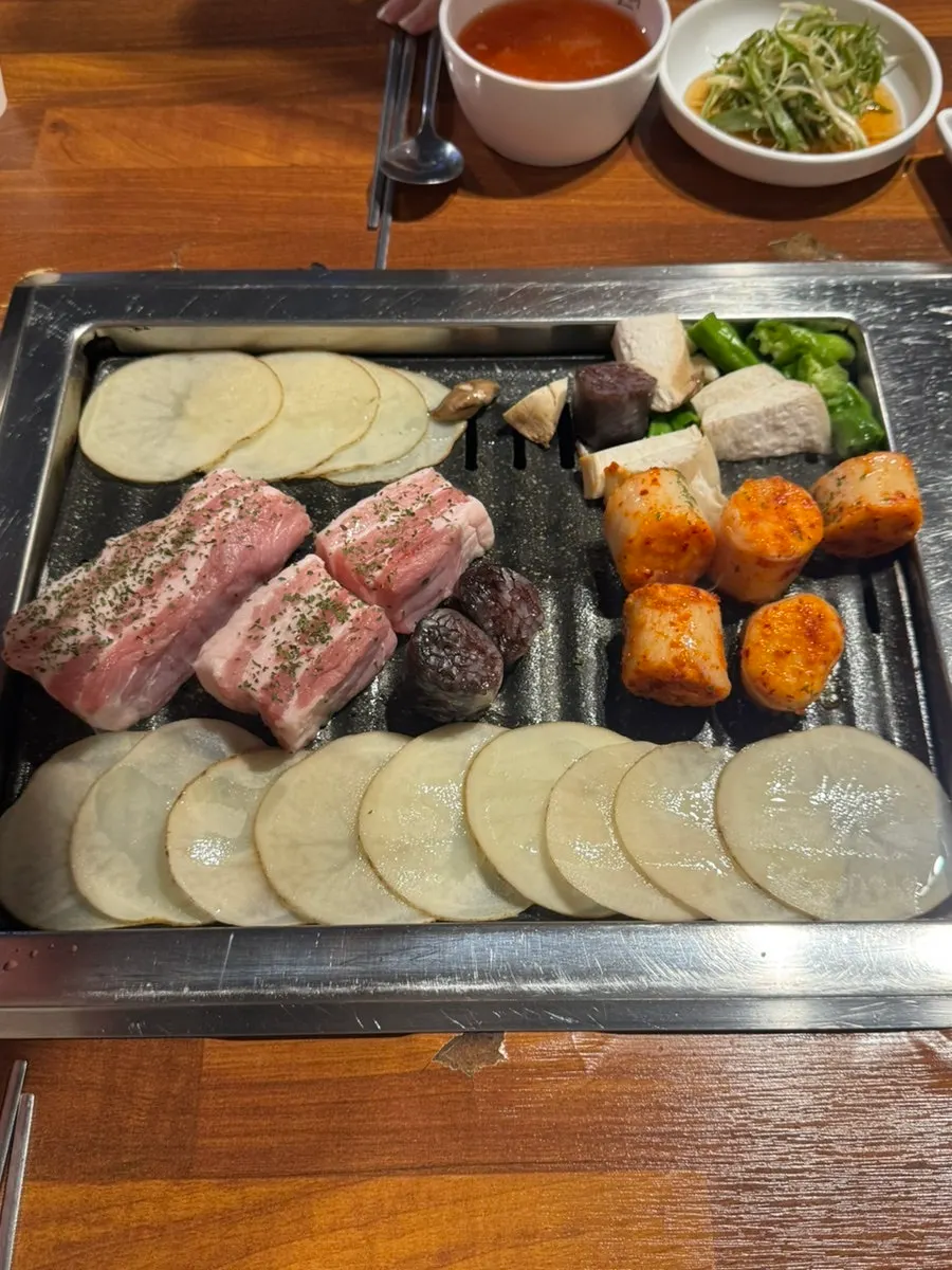 Plate of raw Hanwoo Hwangto fresh pork belly, two servings