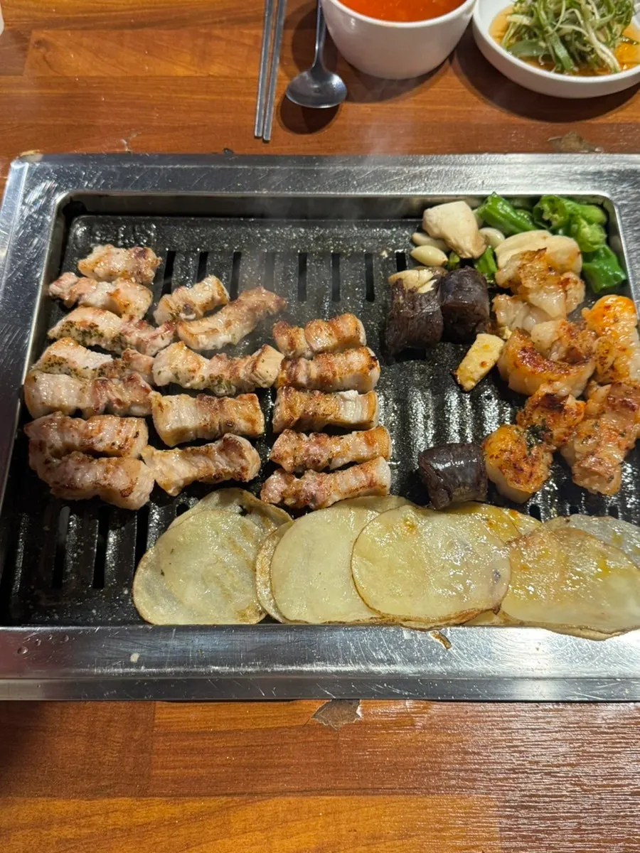 Staff member grilling pork belly on the grill