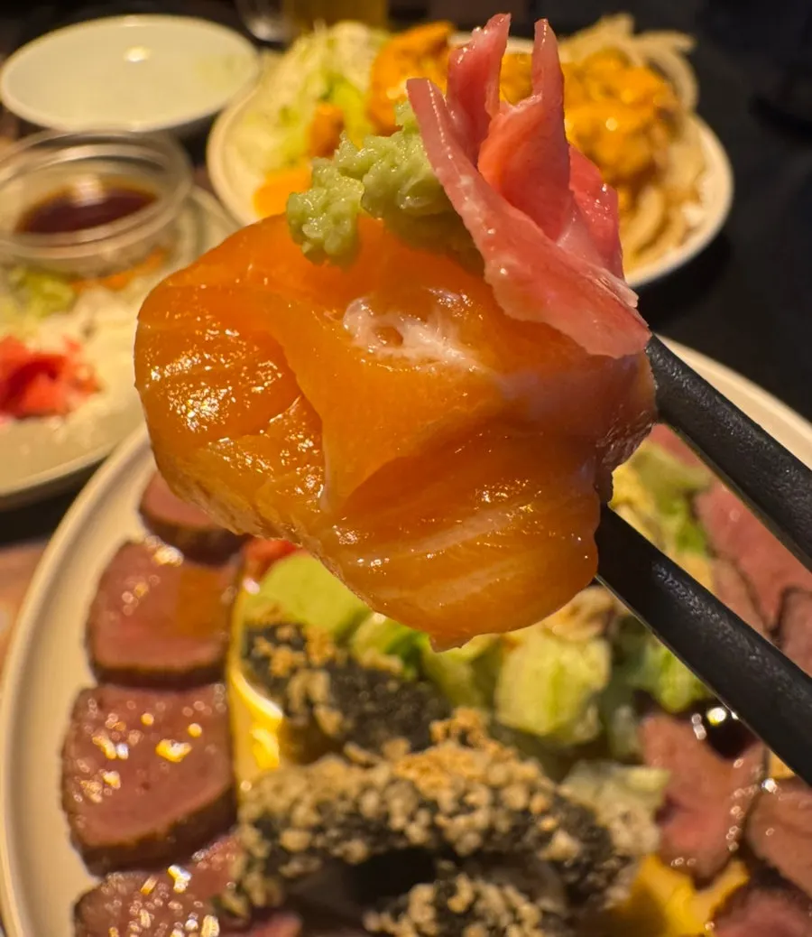 Close-up of salmon sashimi with ginger and sauces