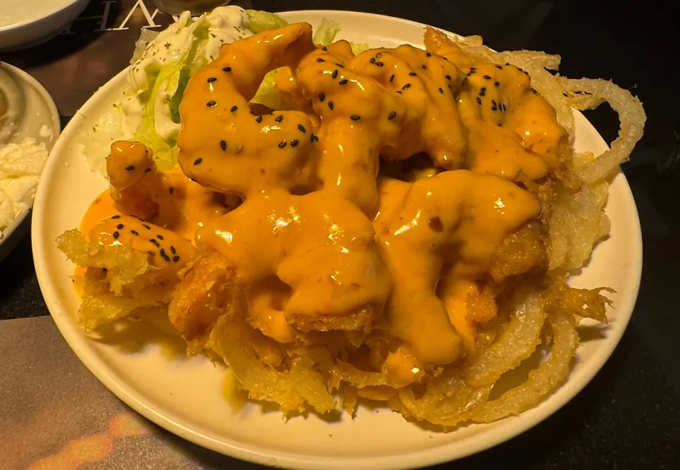 Mala cream shrimp served with a lettuce salad