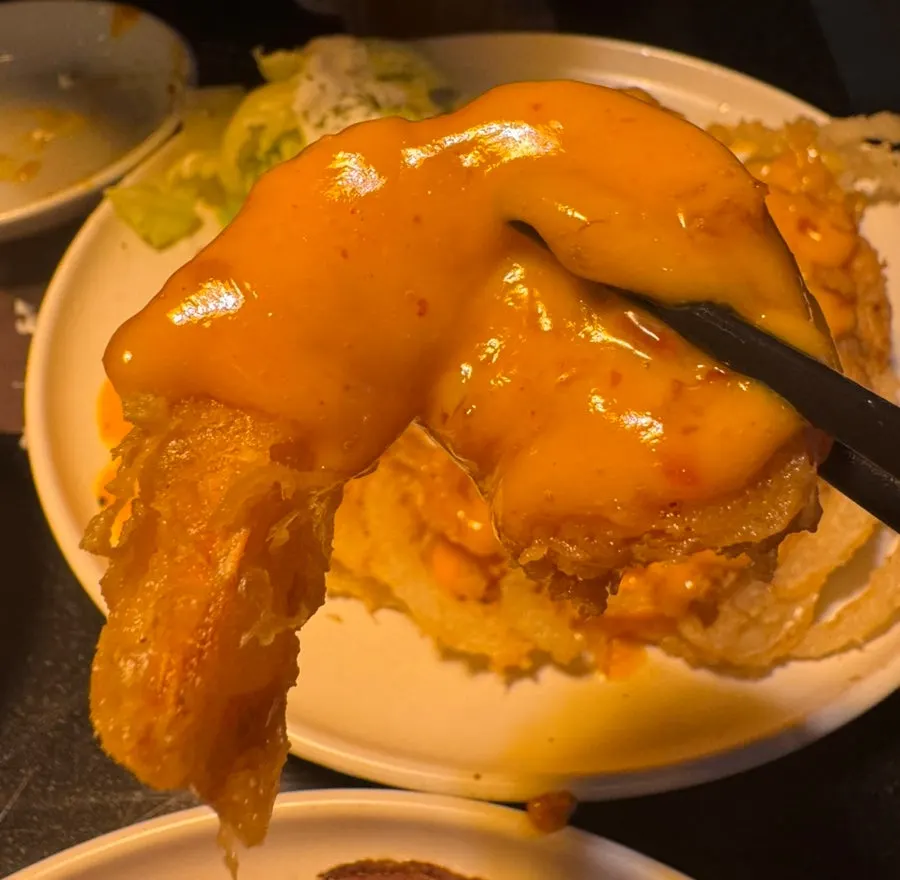 Plate of mala cream shrimp over fried onions