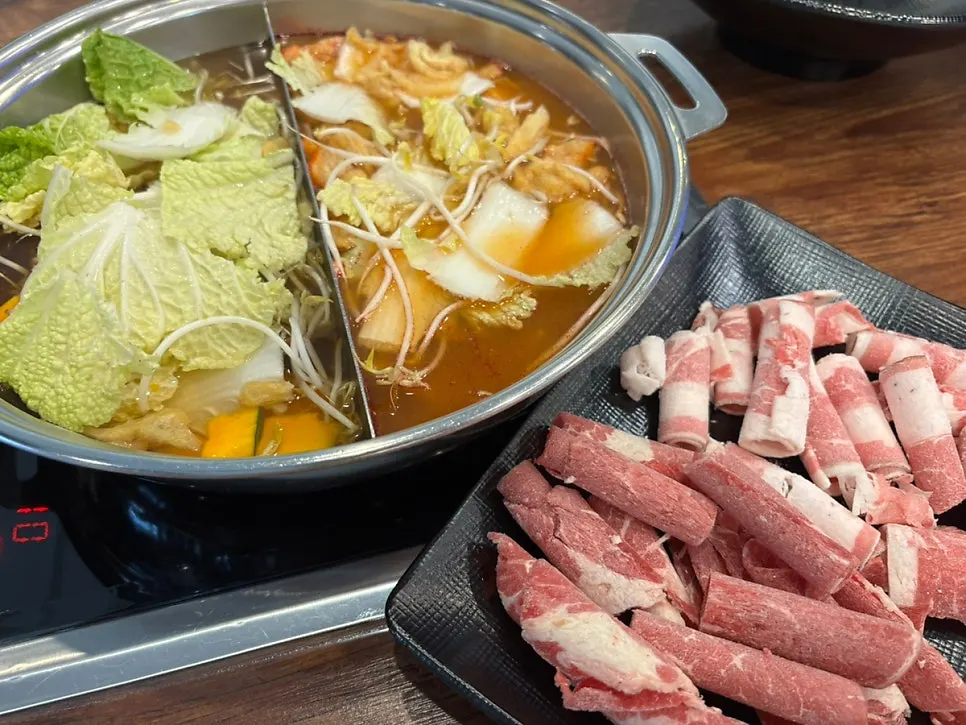 Shabu-shabu simmering in a pot of half-and-half broth