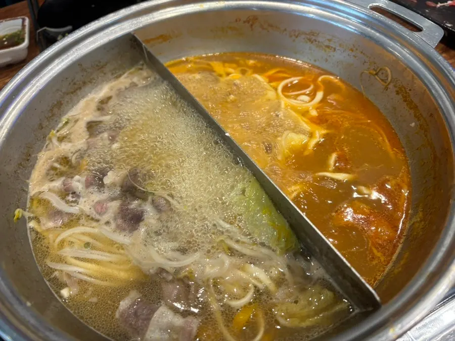Kalguksu noodles and dumpling dough added to the broth