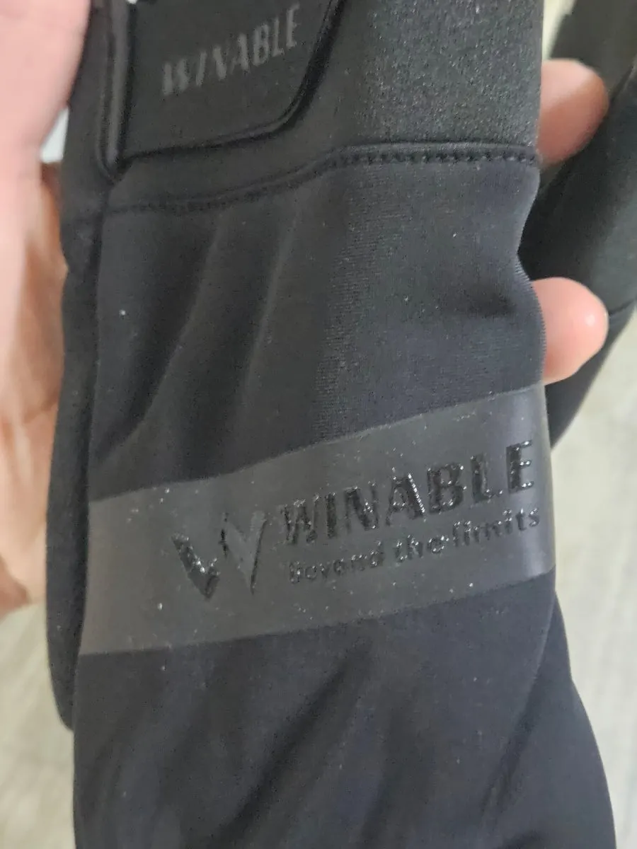 Black gloves worn with a winter outfit