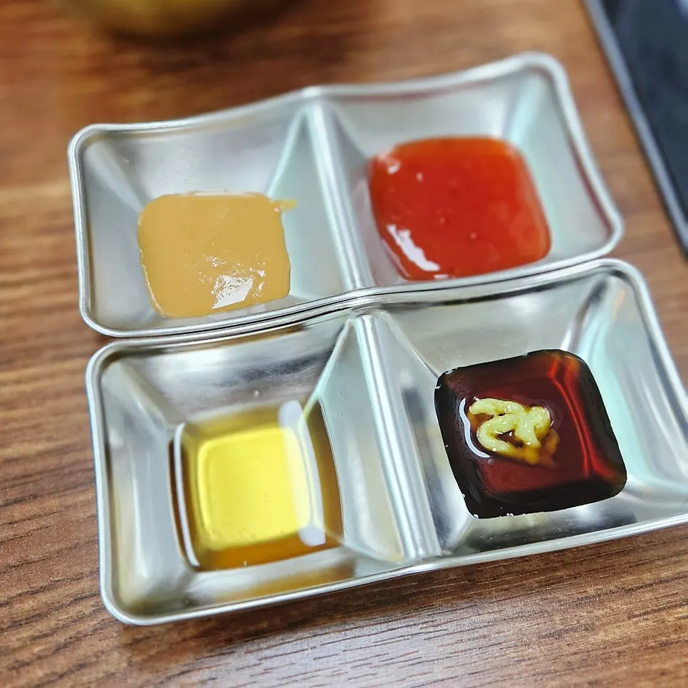 Assorted shabu-shabu dipping sauces including chili and peanut sauce