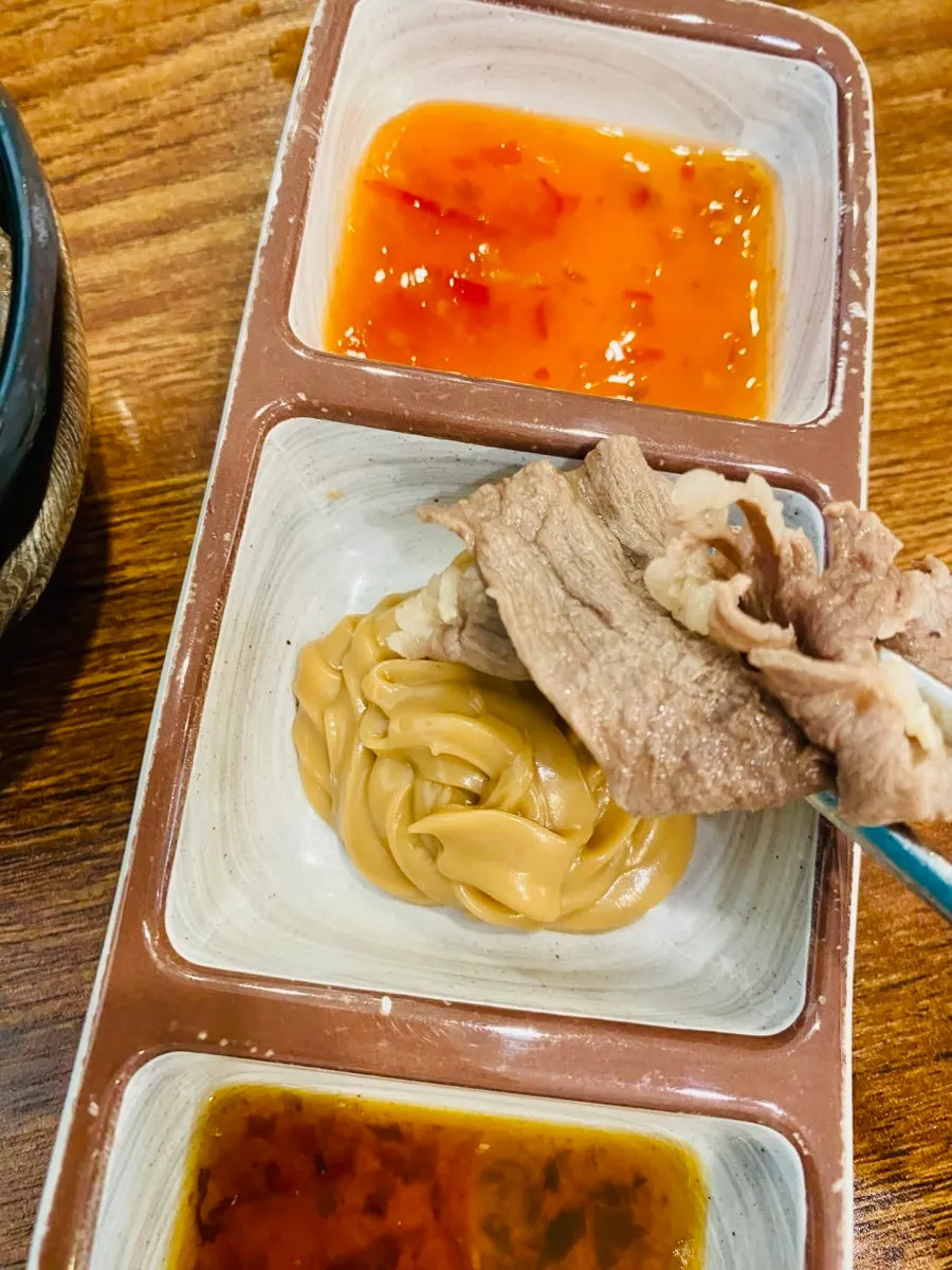 A table of Vietnamese rice-paper wraps with sauces
