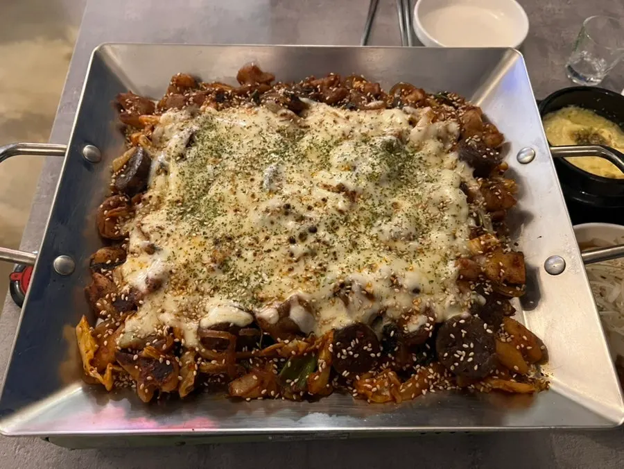 Hot plate of vegetable cheese gopchang covered in cheese