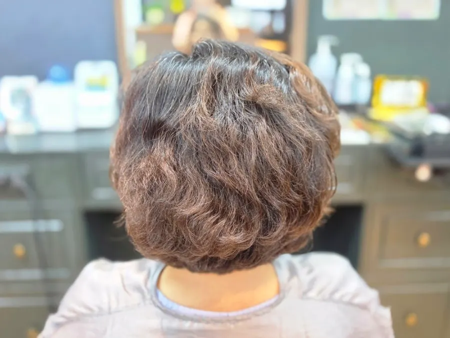 Director checking the scalp and hair condition