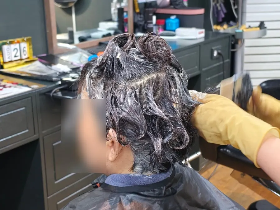 Applying ash khaki dye during the full dye process
