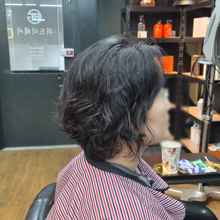 Close-up of the shiny, curled iron perm result