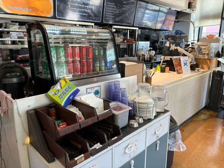 Self-serve bar with water, sauces, and pickles