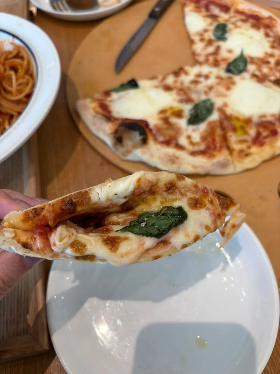Margherita pizza fresh out of the wood-fired oven