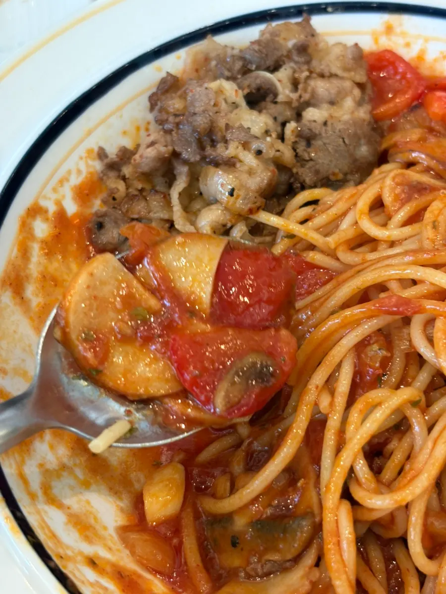 A bite of pasta topped with beef brisket