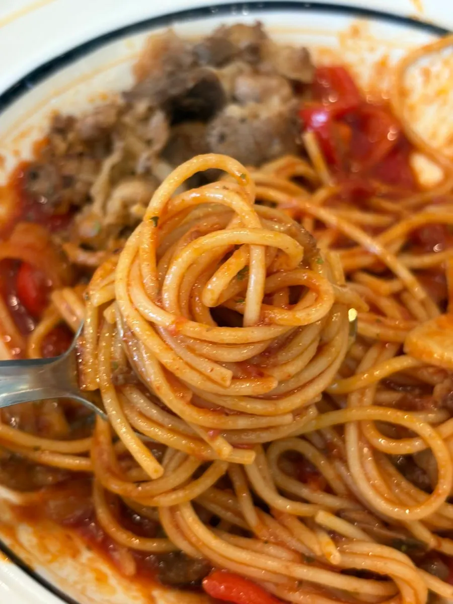 Wood-fired pizza dipped in pasta sauce