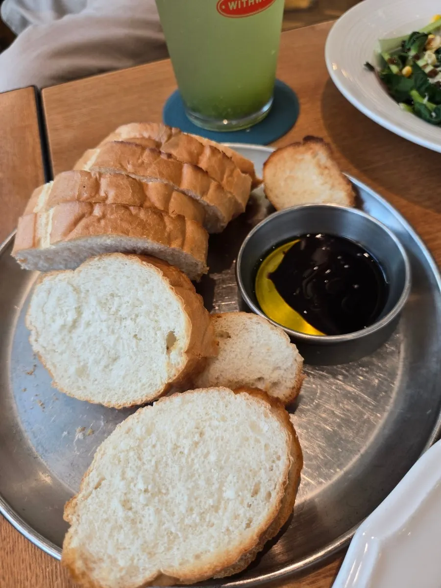 Sliced baguette served with balsamic olive sauce