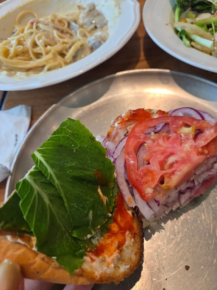 A plate with the sandwich and salad together
