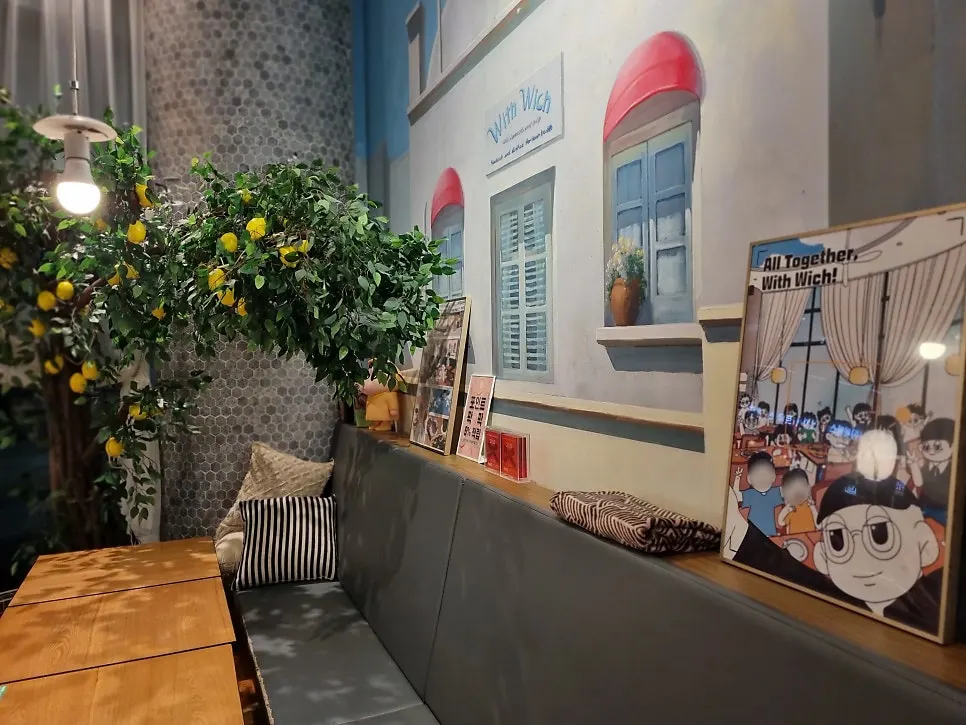 Seating area at Withwich with a Mediterranean mural
