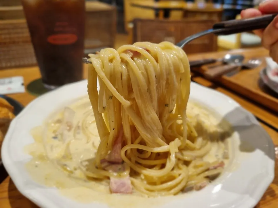 Fork lifting chewy pasta noodles