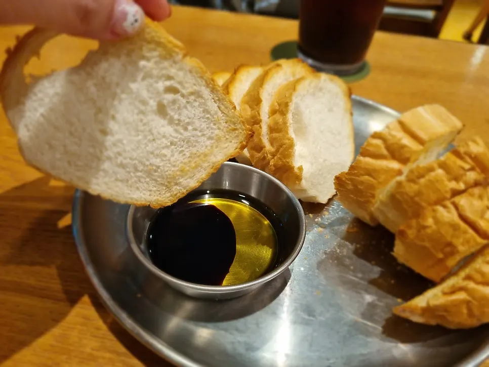 Dipping baguette into the cream sauce