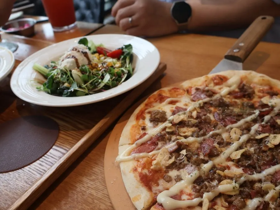 Pasta and wood-fired pizza together on the table
